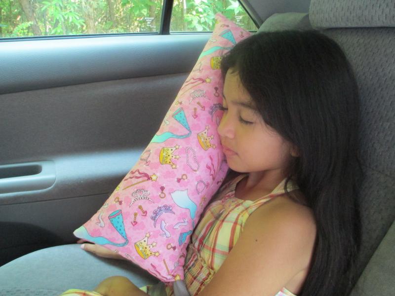 place seat belt over center flat part of pillow and simple fold over.